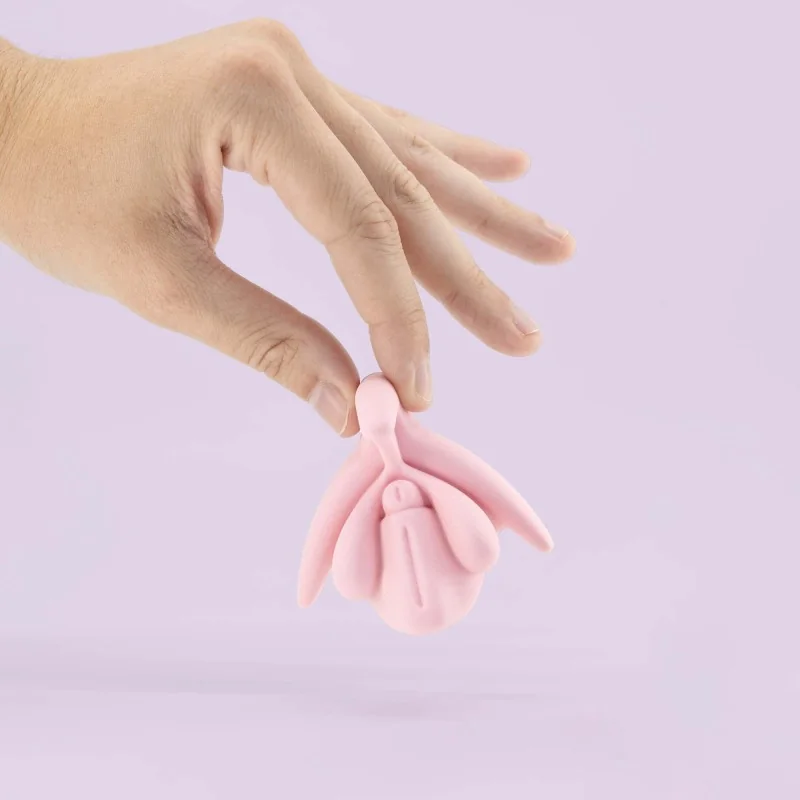 modèle éducatif anatomie du clitoris en 3D rose tenu dans une main